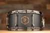 NOBLE & COOLEY 14 X 6.5 WALNUT PLY SNARE DRUM MATTE BLACK WITH WALNUT REVEAL BADGE AND BLACK CHROME FITTINGS